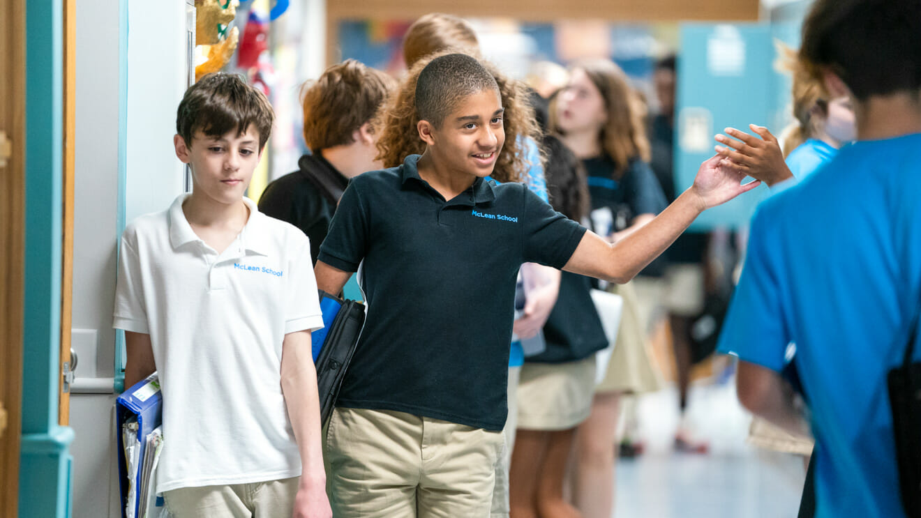 Student offers high five in school hallways