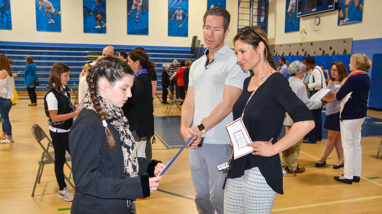 Parents speak to student at event