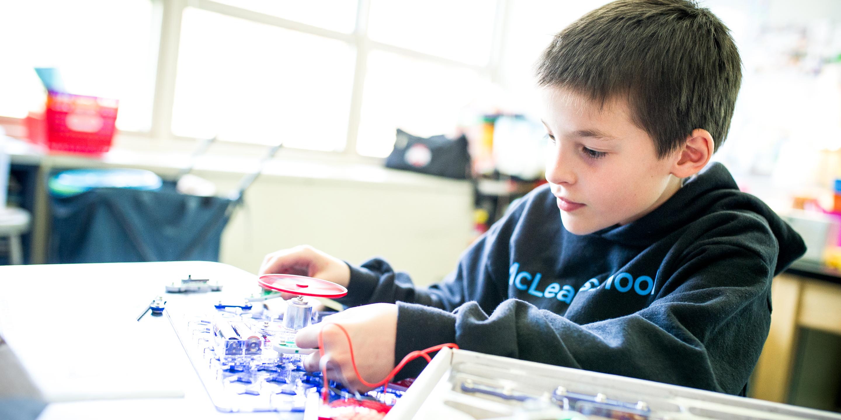 Young student works with circuits in class