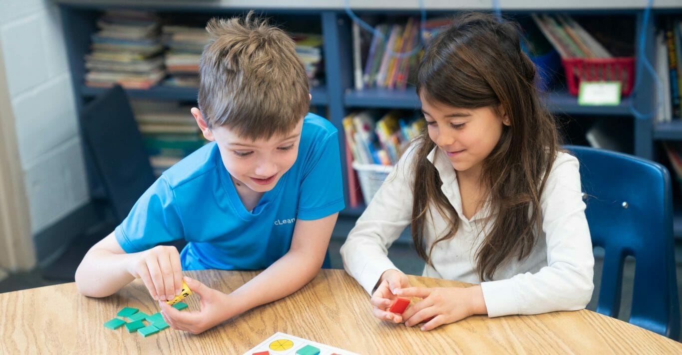 Two young students practice shapes