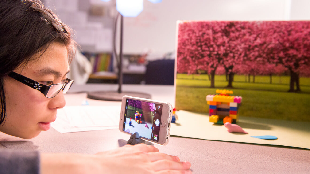 Girl uses phone for staged photography