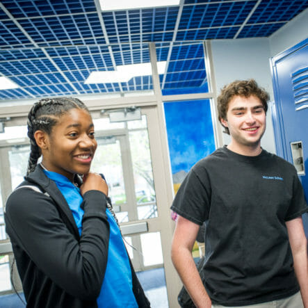 Two upper school students stand in McLean hallway
