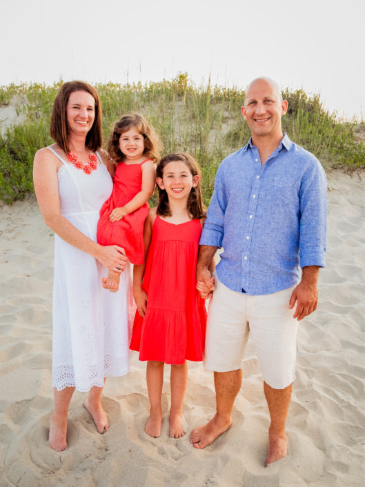 Erin Magnotta, Occupational Therapist at McLean School, smiles with her family on the beach