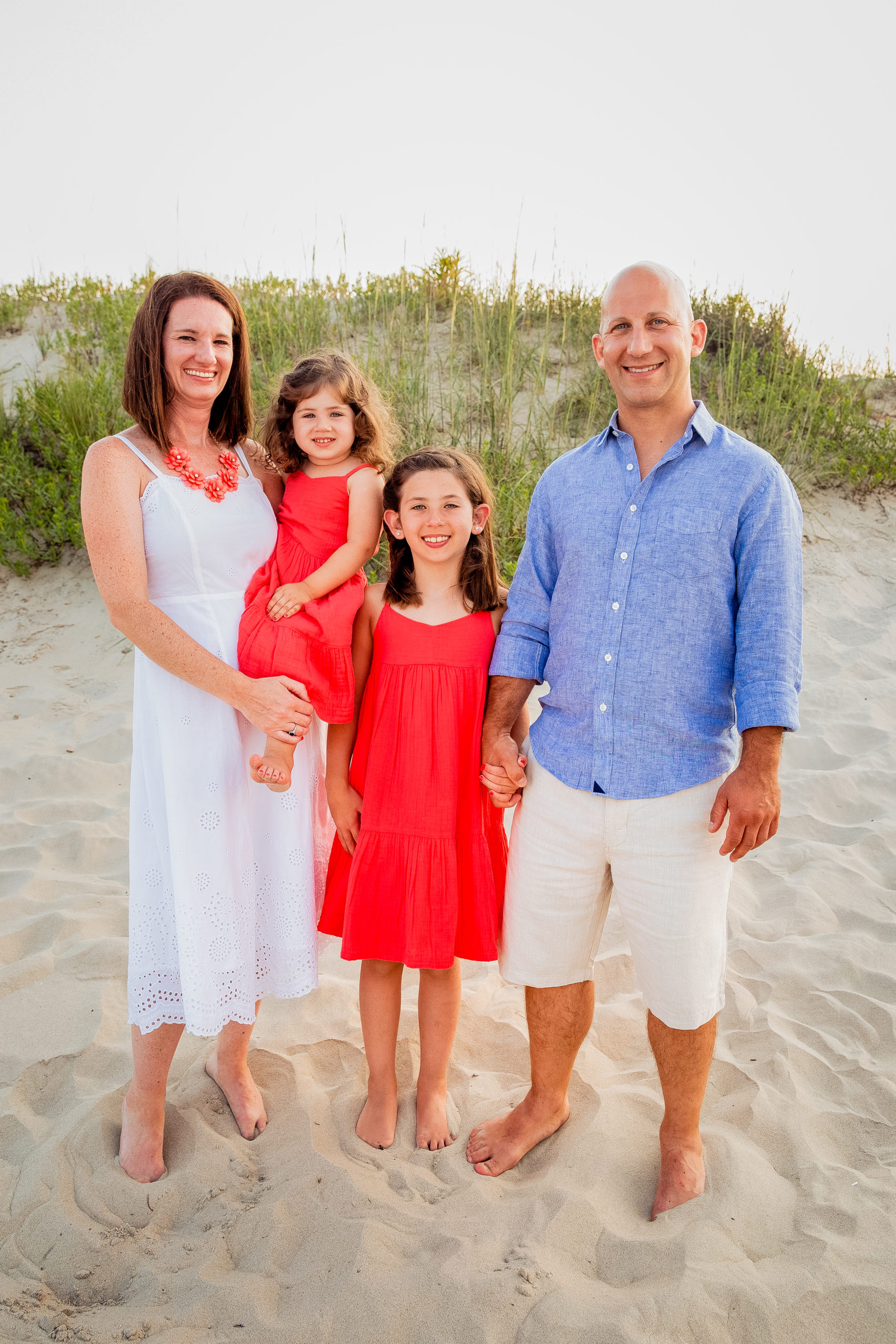 Erin Magnotta, Occupational Therapist at McLean School, smiles with her family on the beach