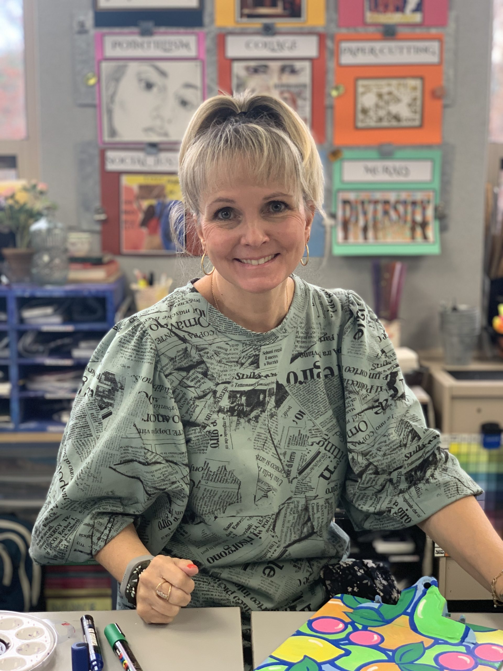 Kymberlee Behnia, Art Department Chair at McLean School, smiles at camera while in her art studio