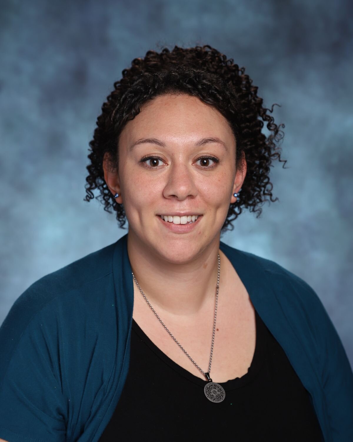 Lauren Merikas, Counselor in the Upper School at McLean School, smiles in front of camera