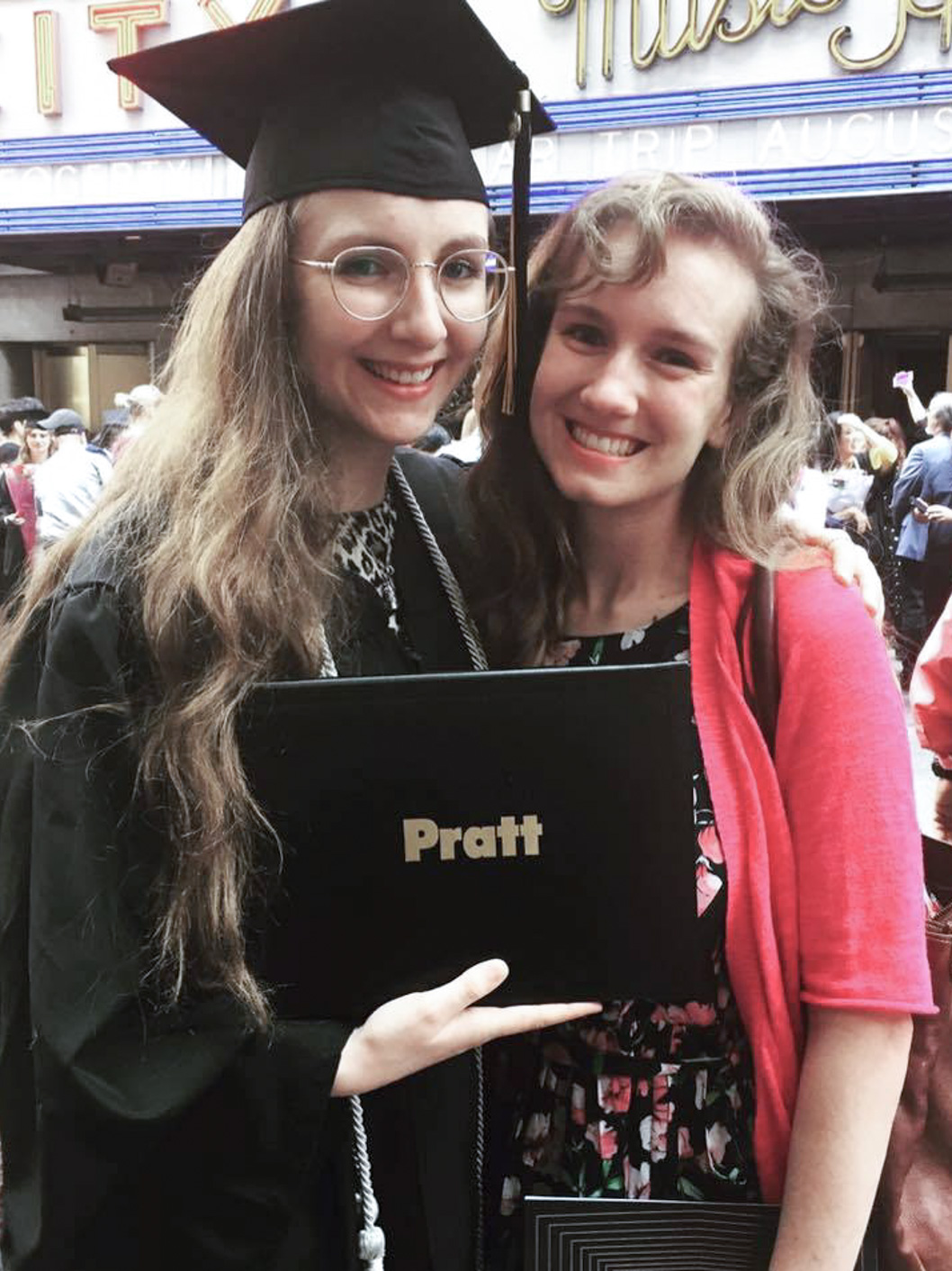Leigh Emig, an Upper School English teacher, posing with a friend on graduation day