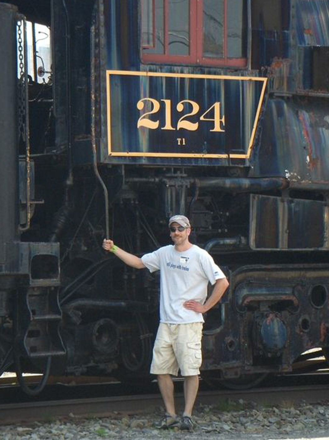 Greg Mugione, Middle School Performing Arts Department Chair at McLean School, stands beside a steam engine