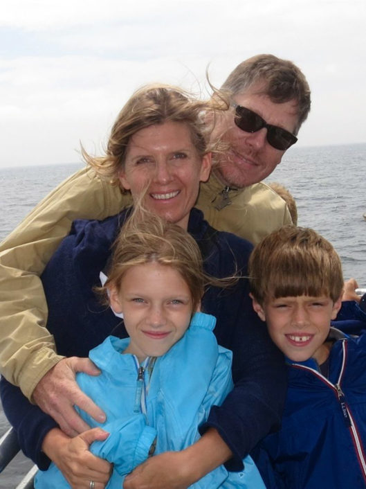 Ruta Puskorius, the Learning Commons Manager and Digital Literacy Coordinator, smiling with her family on a boat
