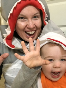 Rebecca Stewart, Coordinator of Learning Services & Math Specialist at McLean School, smiles at camera in a shark suit