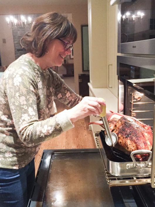 Karen Rumeld, Lower School Art Teacher at McLean School, smiles while cooking