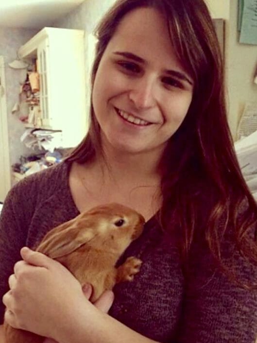 Allison Fletcher, Grade 4 teacher at McLean School, holds bunny and smiles at camera