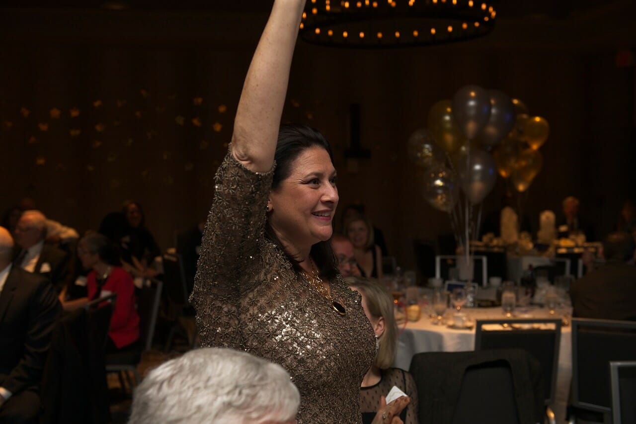a woman with her arm in the air at a McLean event