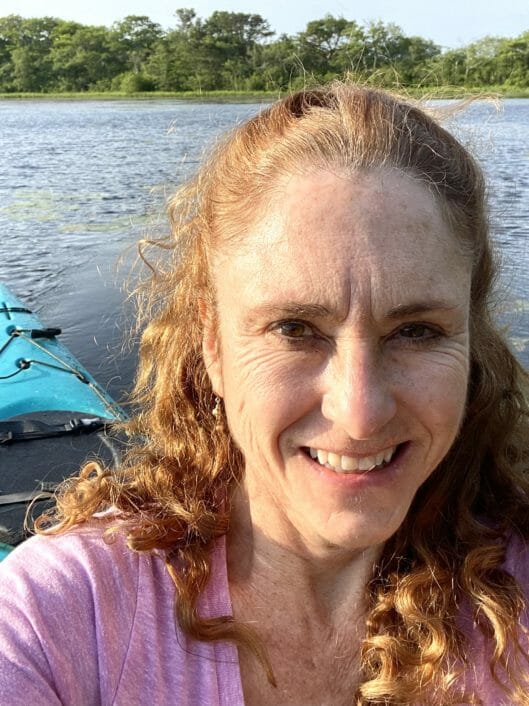 Rebecca Whitmore, Counselor at McLean School, smiles for camera while kayaking