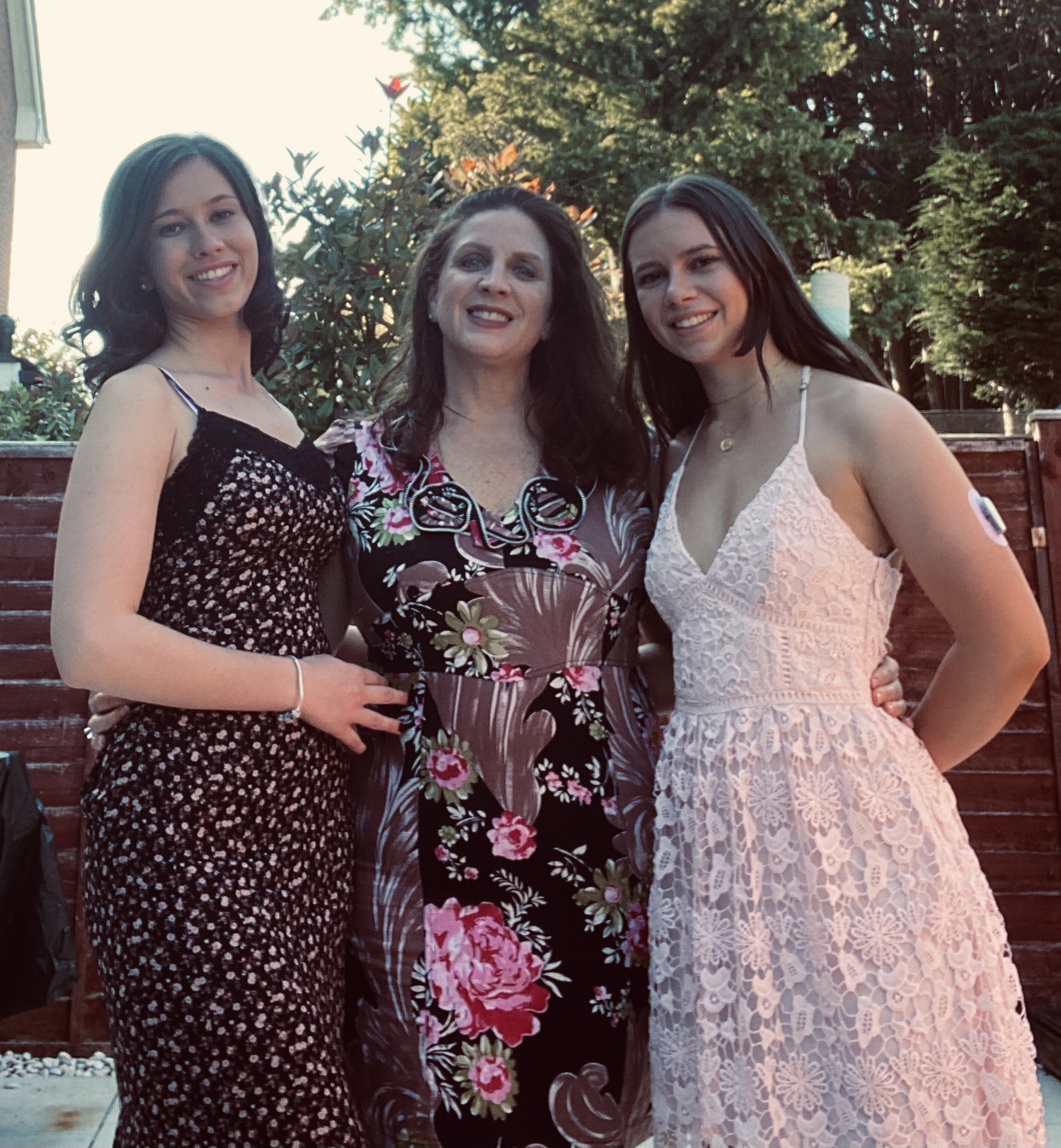 Erika Toren, Director of College Counseling at McLean School, smiles at camera in a colorful flower dress