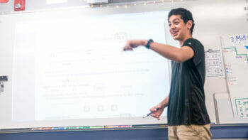 Student Writing on Whiteboard