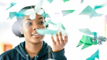 Student Grabbing Paper Shapes