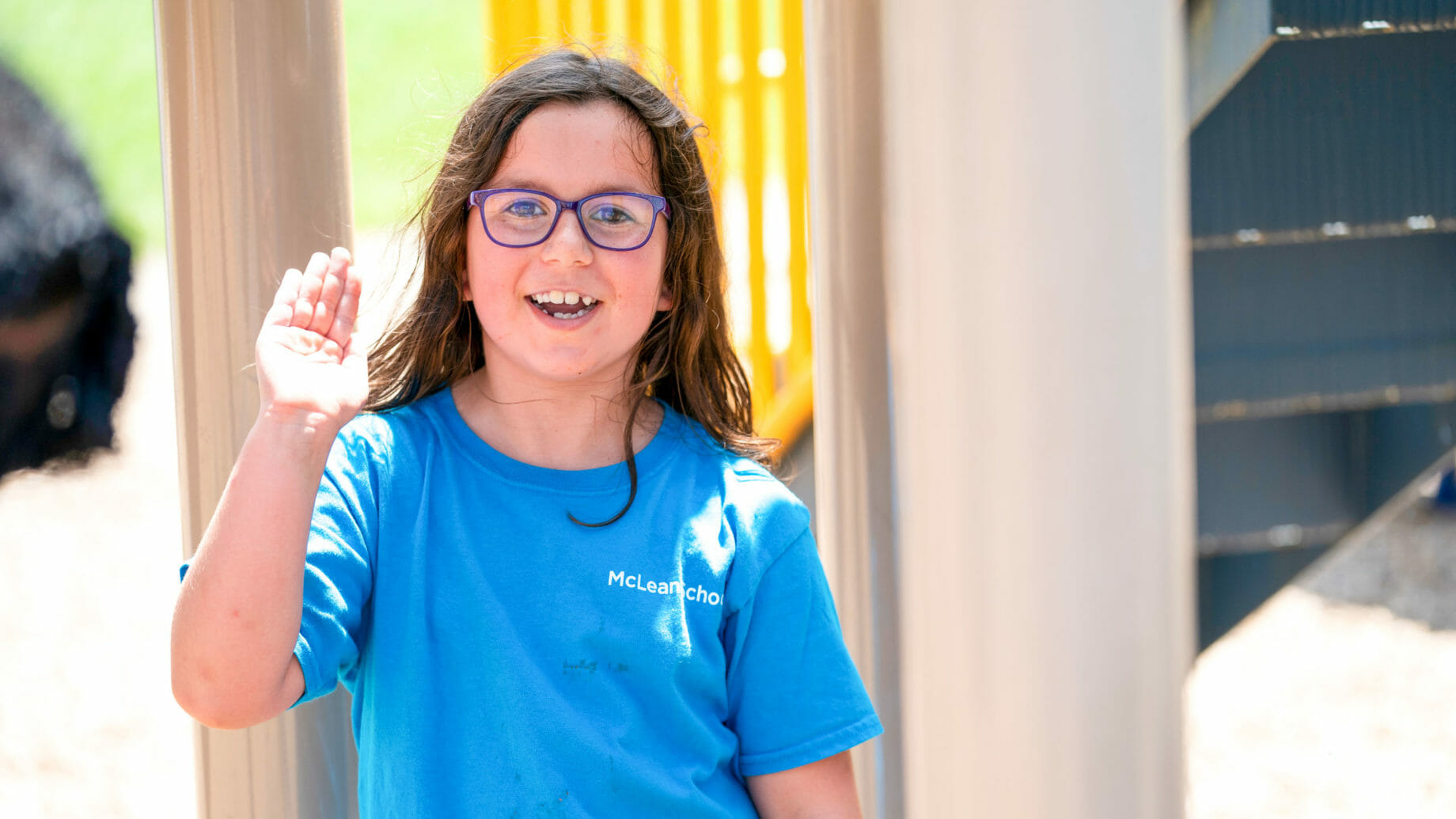 Young Student Waving