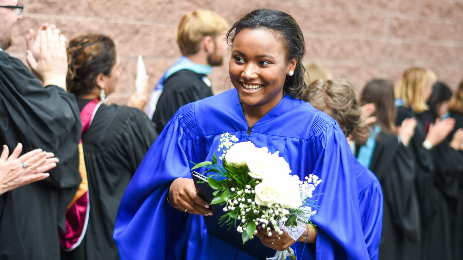McLean Graduate Carrying Flowers
