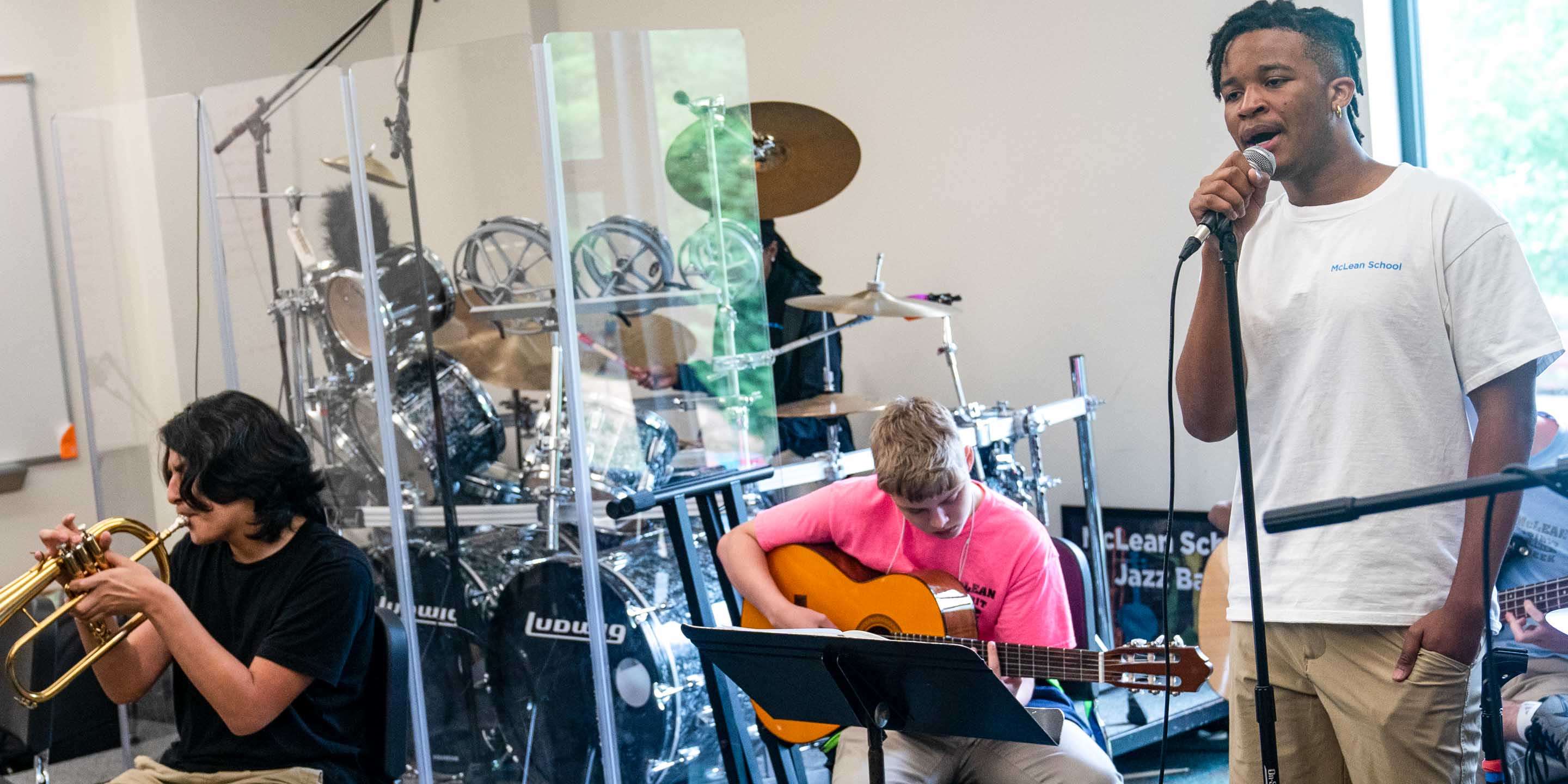 Group of students play instruments and sing