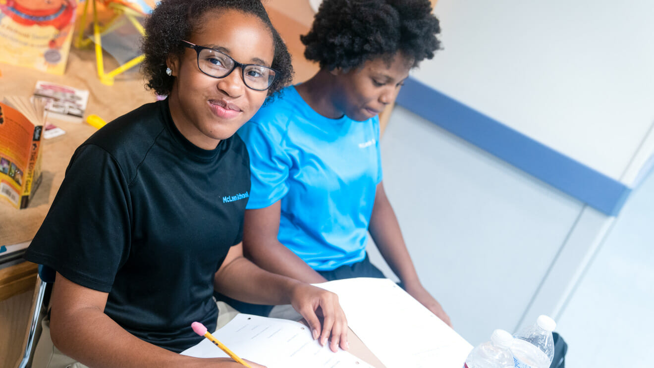 Two upper school girls work on homework