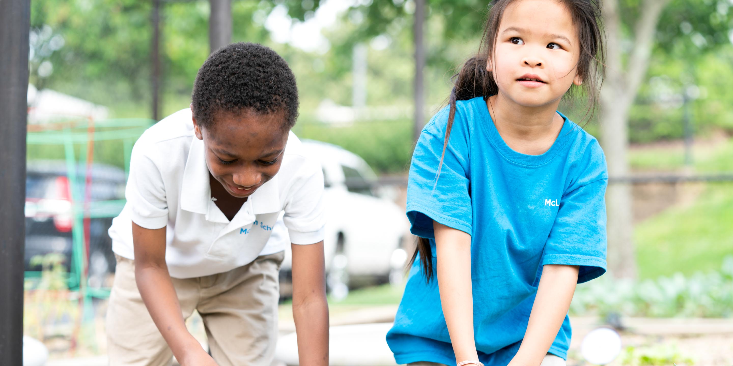 Two young students work in garden