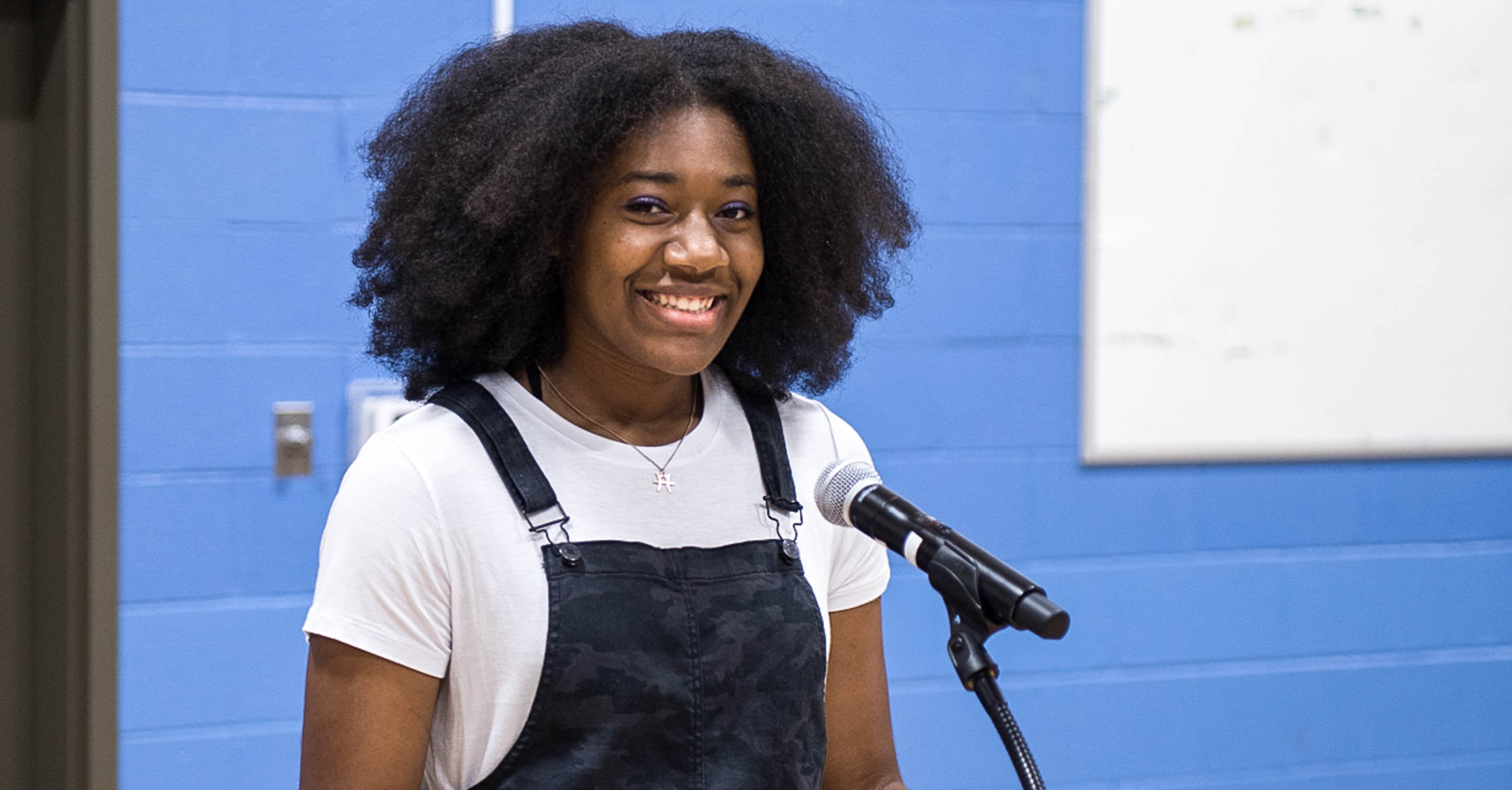 Upper school student speaks at podium