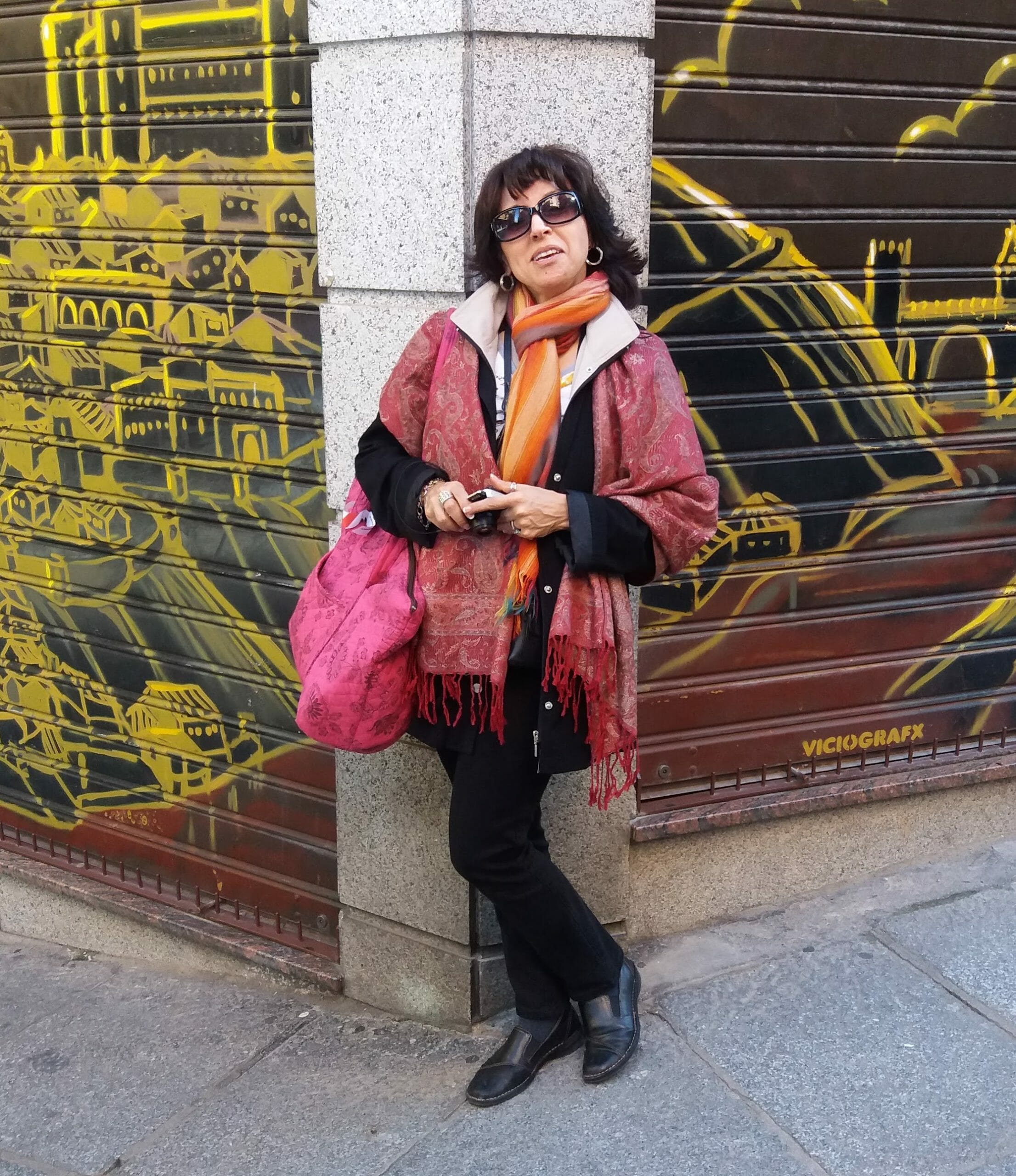 Elizabeth Adum, the Spanish Foreign Language Department Chair, standing in front of a concrete pillar