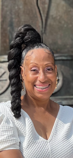 Carolyn Holmes, accounting associate, smiles at camera