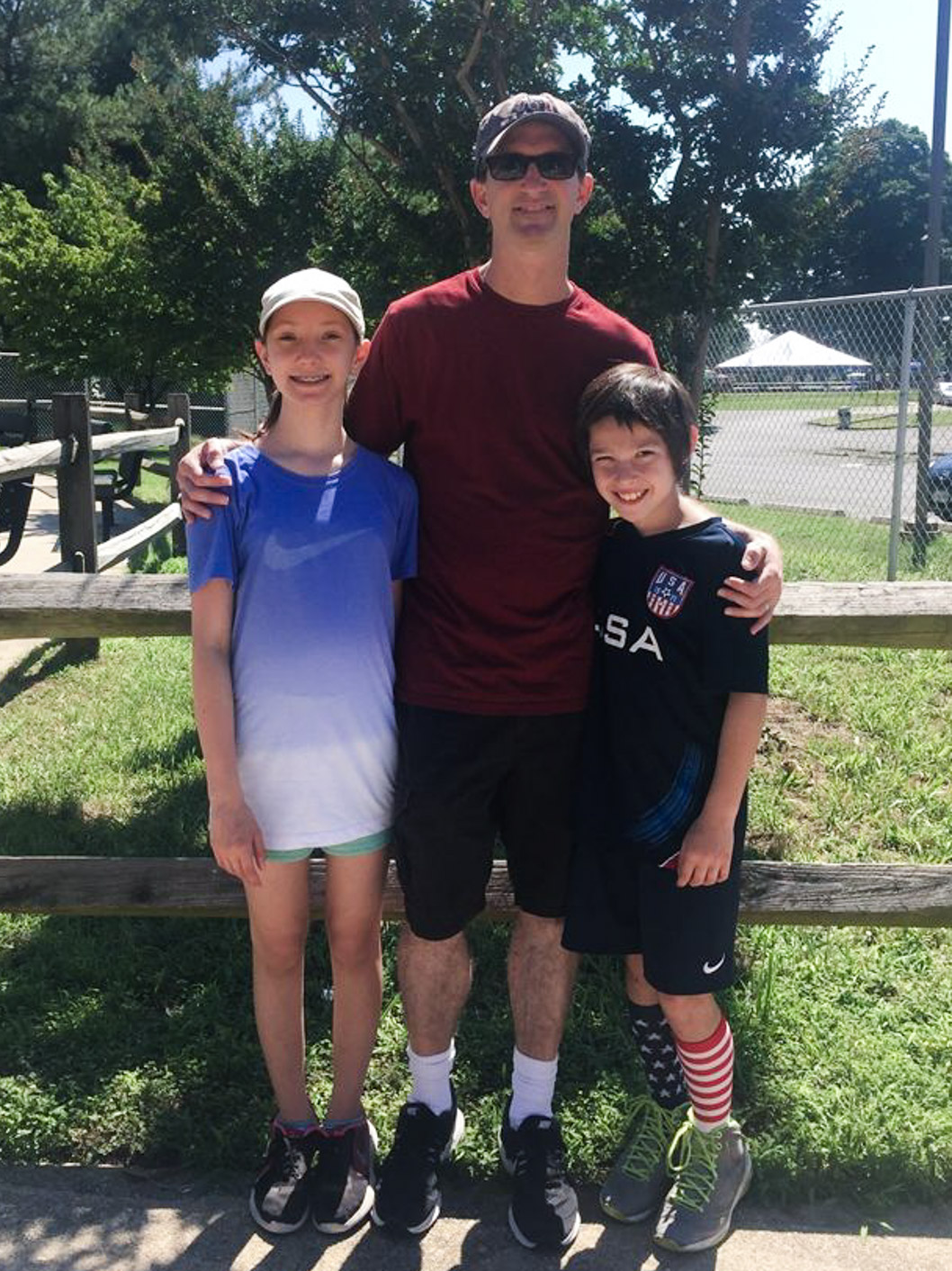 David Goverman, a Math teacher at McLean, standing with his kids outside