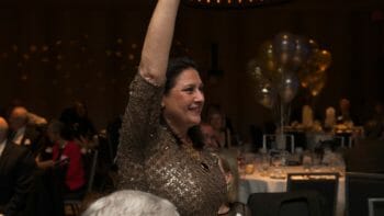 a woman with her arm in the air at a McLean event