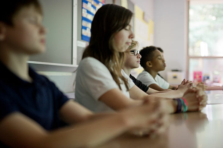 Students meditating at school.