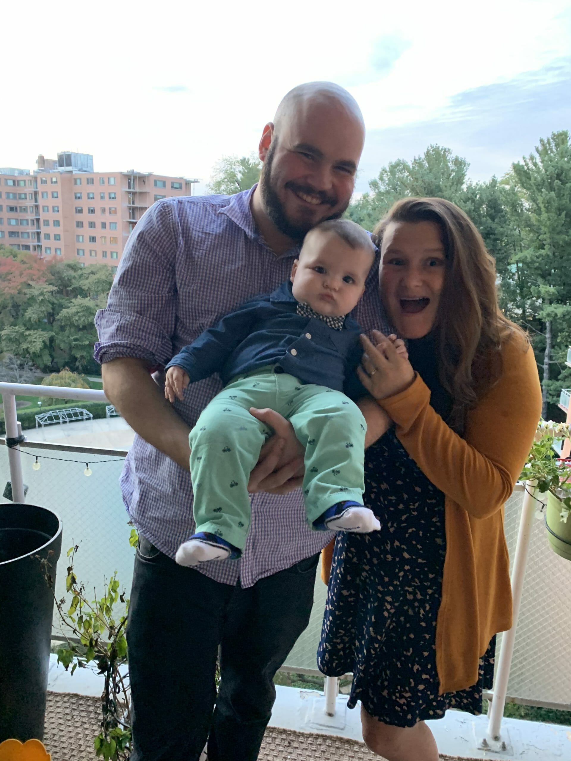 Austin Tucker, Counselor at McLean School, smiles at camera with family