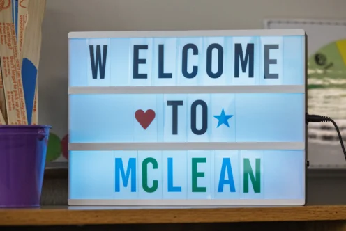 A lightbox sign reads "WELCOME TO MCLEAN" with a red heart and blue star symbols replacing the letter "O.