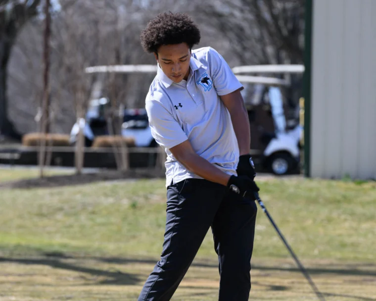 A student playing golf.
